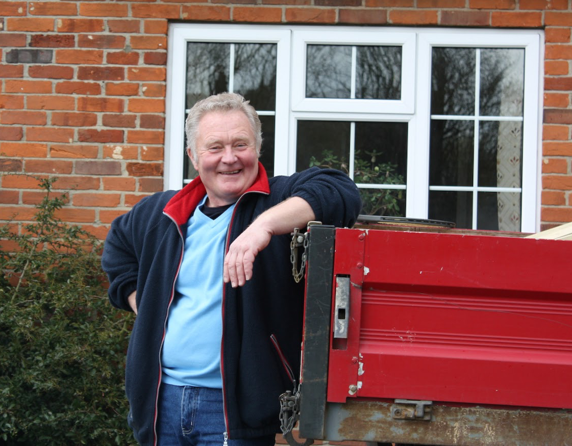 Founder, Kevin Jones; leaning against a red truck.